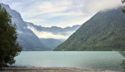 Scenic view of lake and mountains against sky