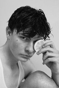 Close-up portrait of shirtless man holding ice cream