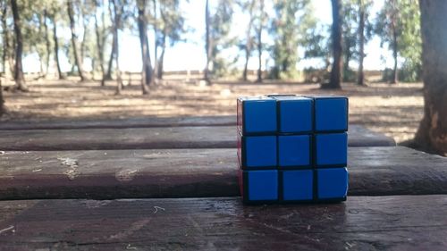 Stack of blue table against trees