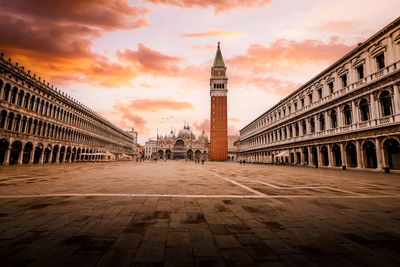 St. mark's square, piazza san marco, in venice with few people and birds in flight at dawn