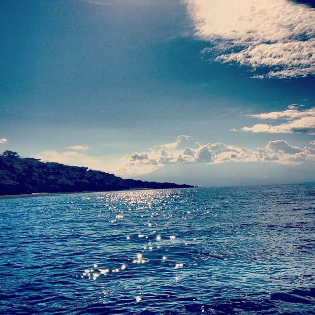 water, tranquil scene, scenics, tranquility, mountain, waterfront, beauty in nature, sky, sea, rippled, nature, blue, mountain range, lake, idyllic, cloud - sky, cloud, non-urban scene, winter, snow