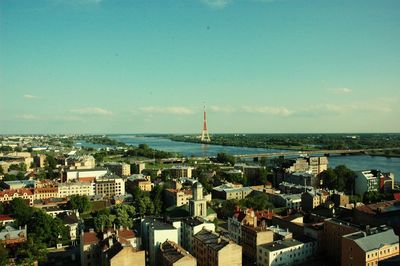 High angle view of city by sea against sky