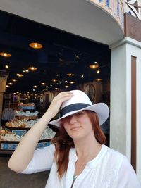 Young woman wearing hat in store