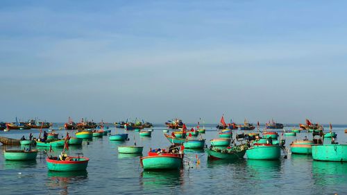 Boats moored in sea against sky