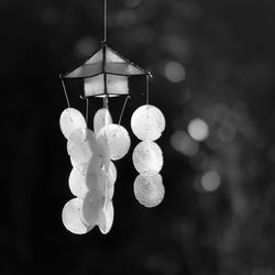 Close-up of illuminated lighting equipment hanging at night