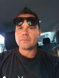 Portrait of young man sitting in car