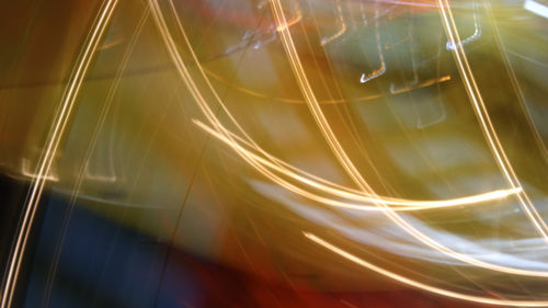 Close-up of light trails against sky at night