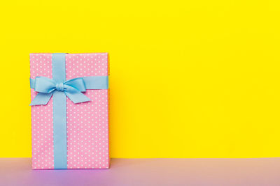 Directly above shot of christmas presents against yellow background