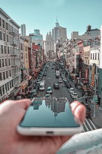 Street amidst buildings against sky in city