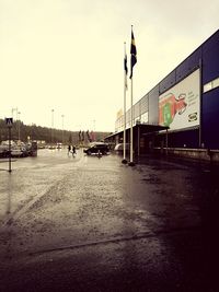 Empty road along buildings