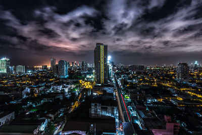 Illuminated cityscape against sky at night