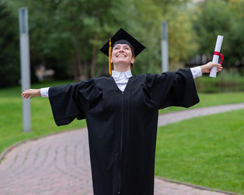 Rear view of woman wearing graduation gown