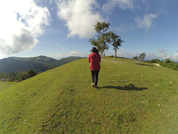 Rear view of person on road against sky