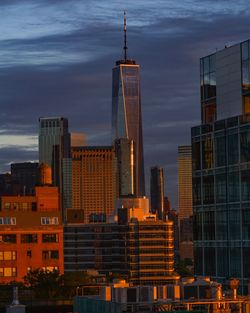 Modern buildings against sky at dusk