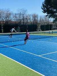 Tennis match , match ball between two tennis players at the madrid city tennis green set court 