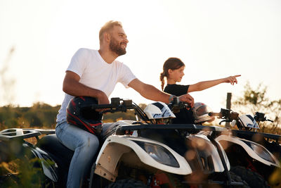 Side view of man riding motorcycle on road