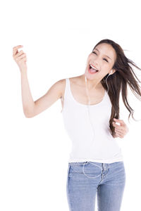 Portrait of smiling young woman against white background