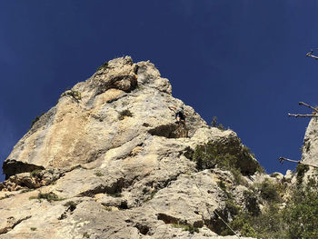 Low angle view of rock against sky