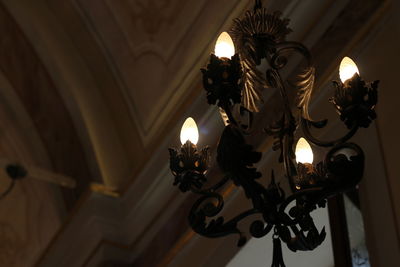 Low angle view of illuminated chandelier in building
