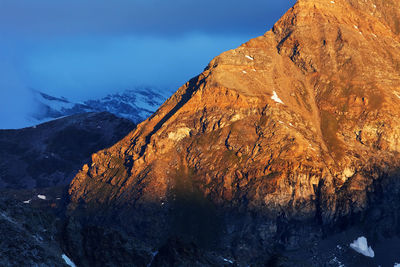 Scenic view of mountains against cloudy sky