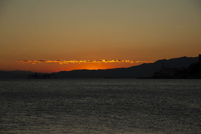 Scenic view of sea against romantic sky at sunset