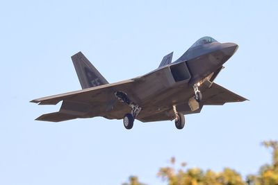 Low angle view of airplane flying against clear sky