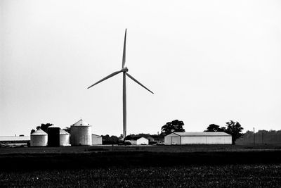 Windmill on field against clear sky