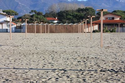 Houses on beach by buildings in city