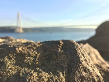 Close-up of rocks on beach against sky