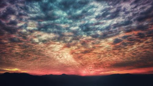 Scenic view of dramatic sky at sunset