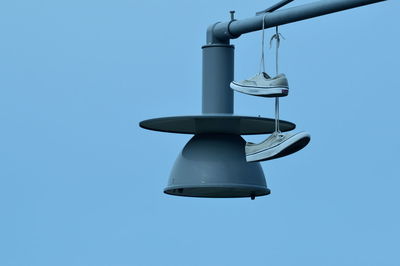 Low angle view of lamp post against clear blue sky