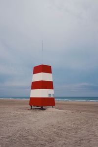 Lifeguard hut on beach against sky