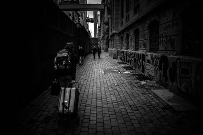People walking on narrow street in city