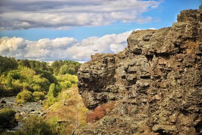 Rock formation on mountain against sky