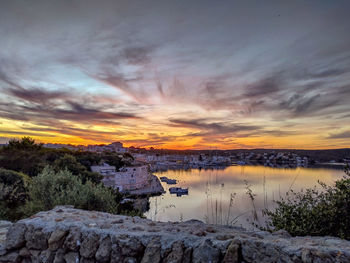 Scenic view of lake against sky during sunset