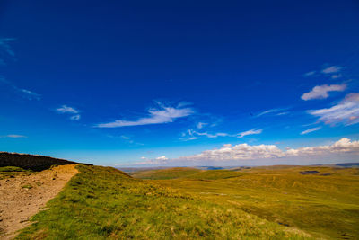 Scenic view of landscape against blue sky