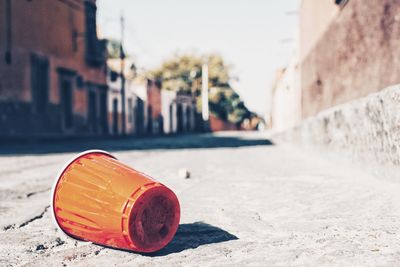 Close-up of bottle against wall in city