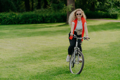 Man with bicycle on field