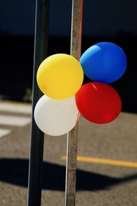 Close-up of multi colored balloons on street