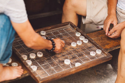 Midsection of people playing leisure game