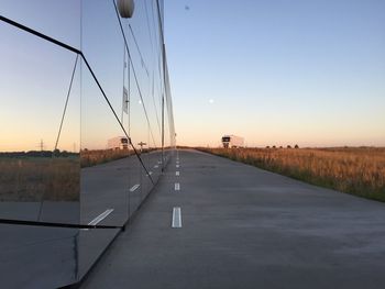 Empty road passing through field