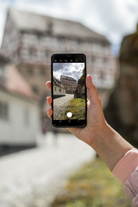 Woman photographing through smart phone