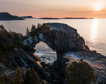 Berry head arch at sunrise, along the east coast trail of newfoundland, canada