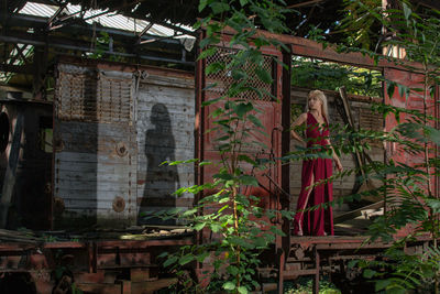 Woman standing by plants