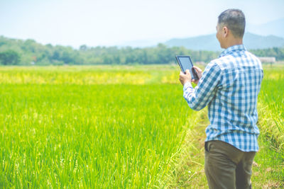 Side view of man using digital tablet