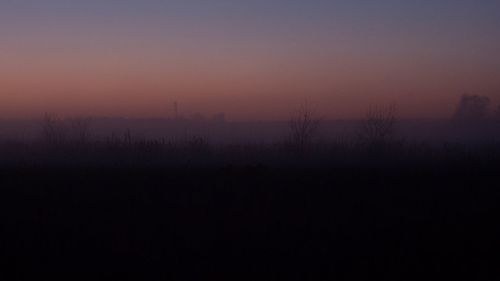Silhouette landscape against sky during sunset