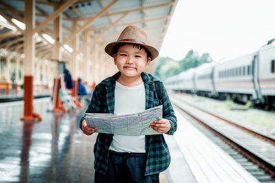 Portrait of boy standing on train