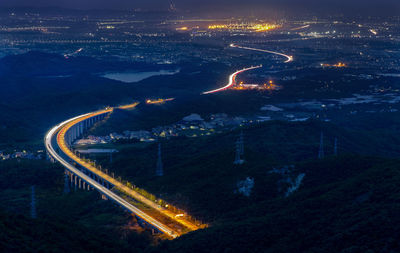 High angle view of illuminated cityscape at night