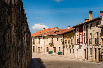 Street amidst buildings in city against sky