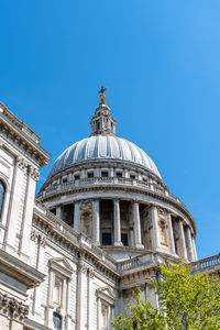 Low angle view of historical building against blue sky